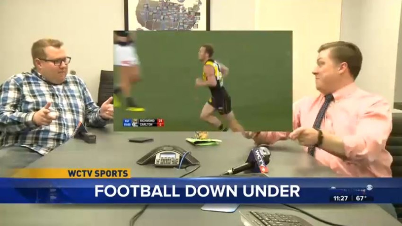 An American TV news anchor is taught the rules of footy by a colleague.