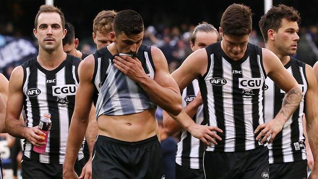 Scott Pendlebury leads Collingwood off after losing to Carlton. Picture: George Salpigtidis