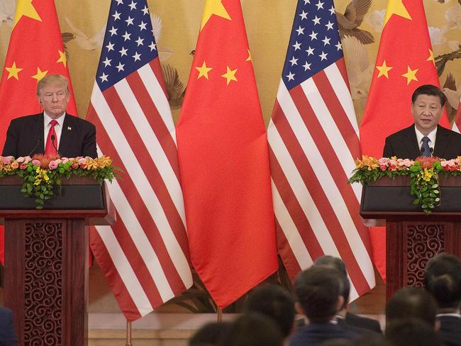 (FILES) In this file photo taken on November 9, 2017 US President Donald Trump (L) and China's President Xi Jinping speak during a joint statement in Beijing. - Donald Trump has escalated his feud with China into a full-press offensive that has drawn comparisons to the Cold War. Now the question on both sides of the Pacific is, how will it end? (Photo by Nicolas ASFOURI / AFP)