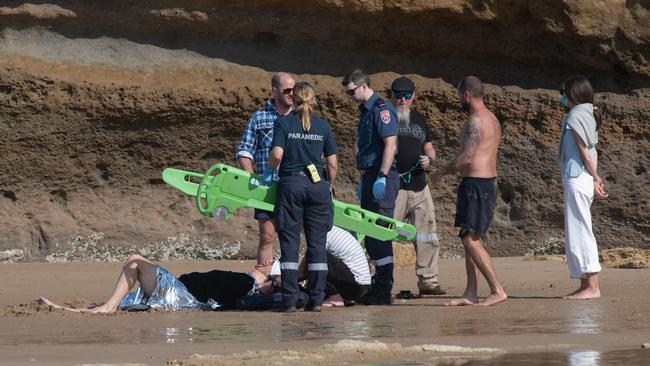 Man rescued after hitting head on reef at Bird Rock, Jan Juc. Locals and paramedics worked together to treat and move the man, using a resident's ute. Pictures: Shaun Viljoen