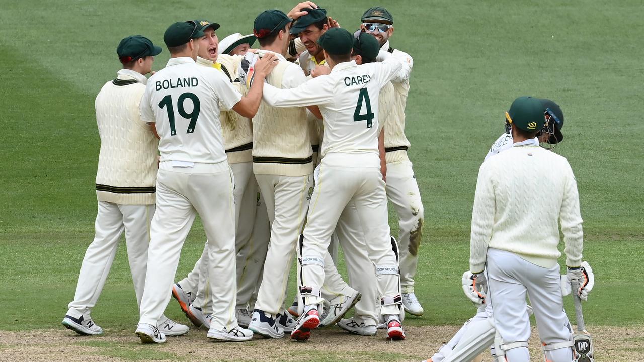 Mitchell Starc is congratulated after an early wicket on day four.