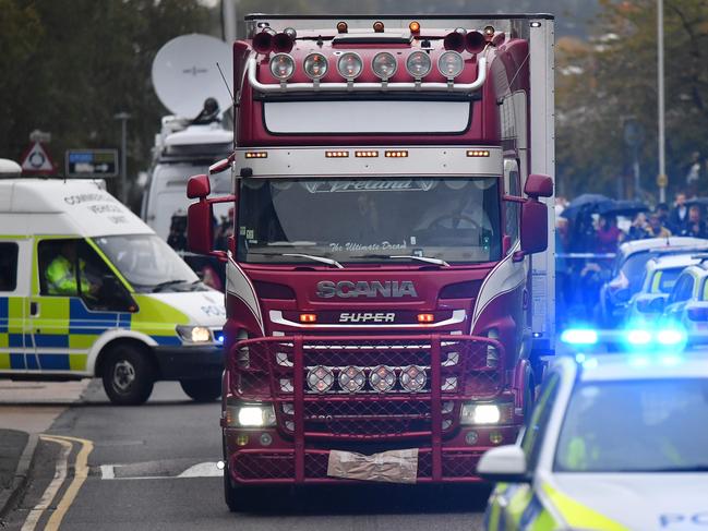 Police officers drive away a lorry in which 39 dead bodies were discovered sparking a murder investigation at Waterglade Industrial Park in Grays, east of London. Picture: AFP