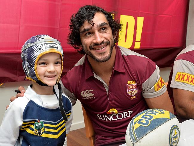 PROSERPINE, AUSTRALIA - JUNE 30: Johnathan Thurston poses for a photo with a young fan during the Queensland Maroons State of Origin fan day on June 30, 2015 in Proserpine, Australia. (Photo by Bradley Kanaris/Getty Images)