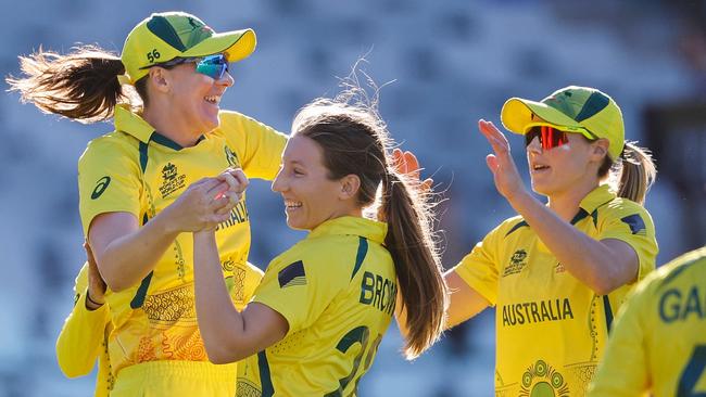 Australia's Darcie Brown (2nd L) celebrates with teammates after the dismissal of India's Richa Ghosh (not seen) during the semi-final T20 women's World Cup cricket match between Australia and India at Newlands Stadium in Cape Town on February 23, 2023. (Photo by Marco Longari / AFP)