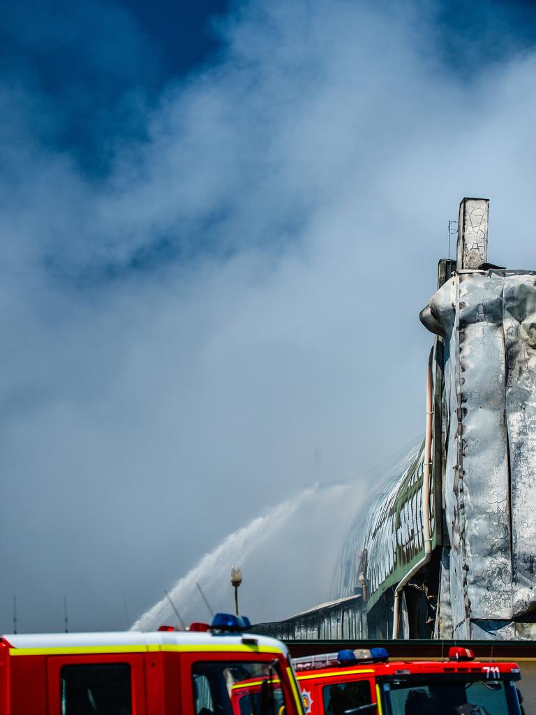 Emergency services continue to work on the huge fire at the Thomas Foods abattoir in Murray Bridge the morning after it broke out. Picture: AAP / Roy Vandervegt