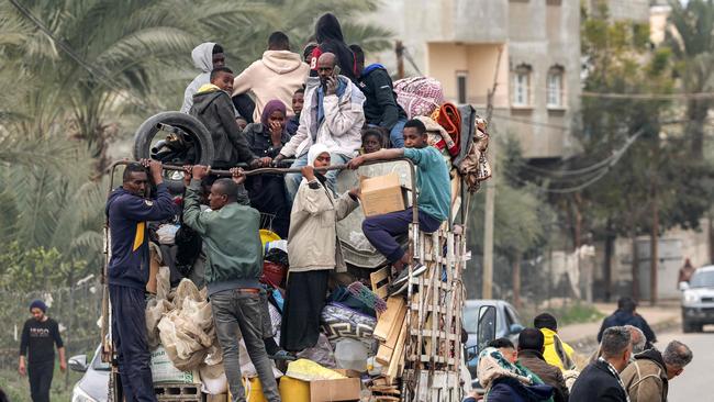 People evacuating from a tent camp ride in the back of a truck with belongings as they flee from Rafah. Picture: Mohammed Abed/AFP