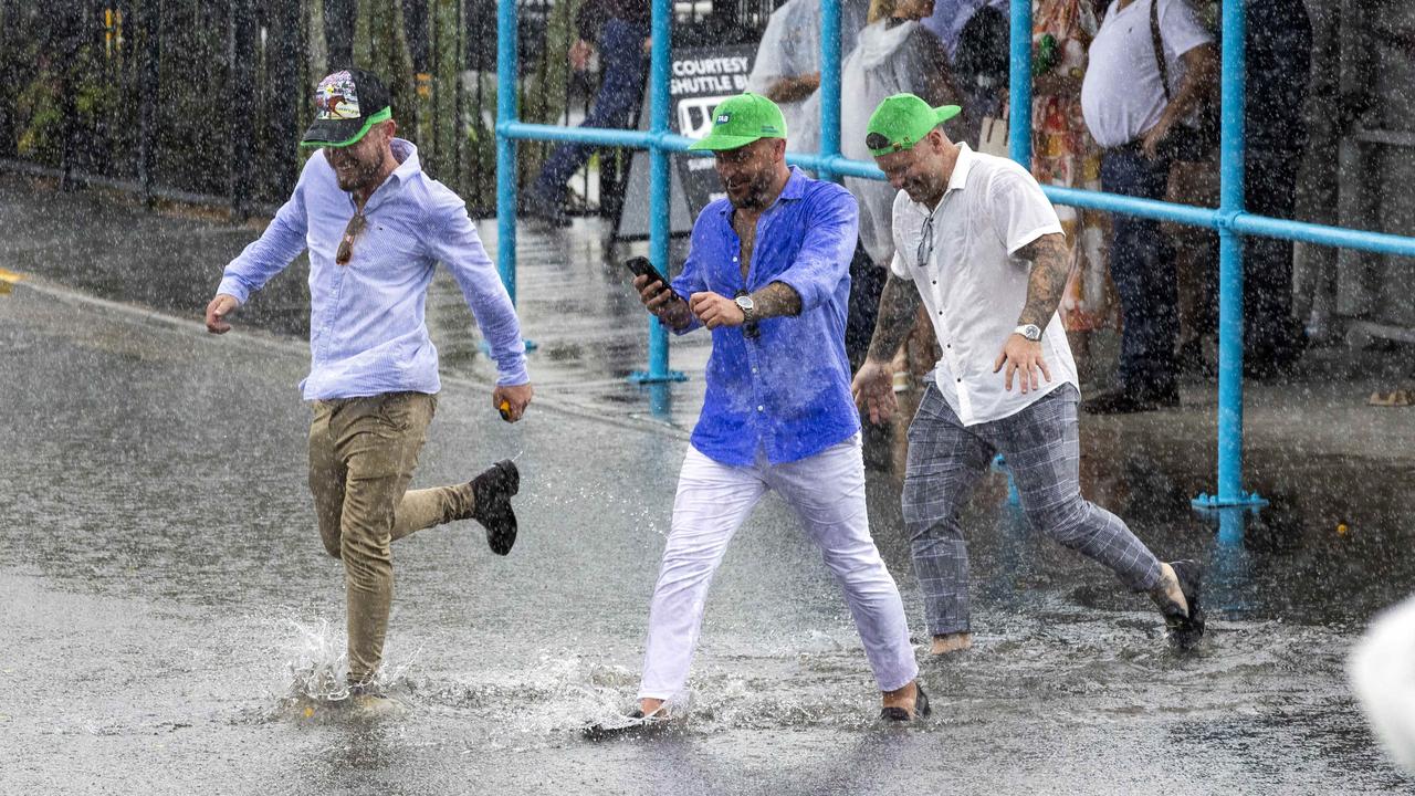 Racegoers leave the Gold Coast Turf Club after the Magic Millions race day was postponed. Picture: Richard Walker