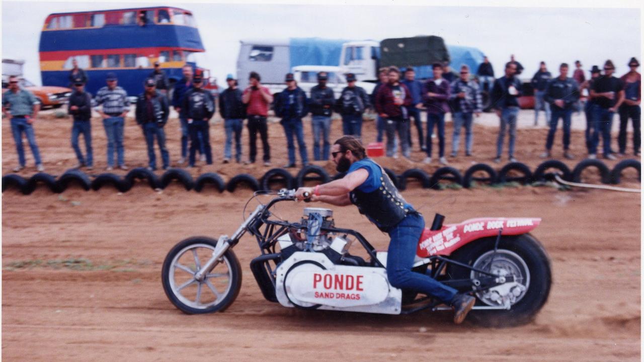 Hell's Angel Mark 'Tomo' Thompson drags his V8 Chevrolet-powered motorcycle along the sand track at Ponde rock music festival, held by the Hell's Angels Motorcycle Club in Ponde near Mannum on 23 Feb 1992.