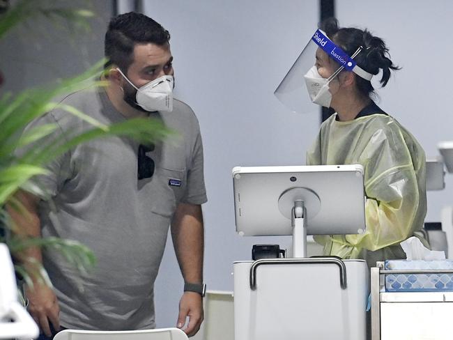 Frontline workers at Sydney International Airport’s pre-flight testing clinic. Picture: NCA NewsWire / Jeremy Piper