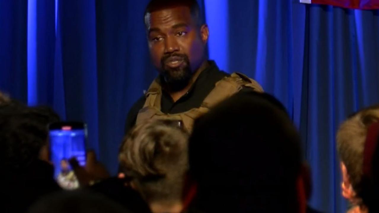 Kanye was wearing a security vest, and had the number 20 - for 2020 - shaved into his purple hair.