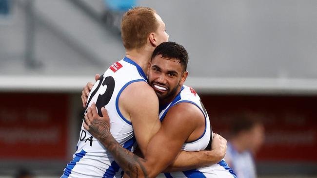 Ben McKay (left) and Tarryn Thomas embrace after a North Melbourne goal. Picture: Michael Willson/AFL Photos via Getty Images