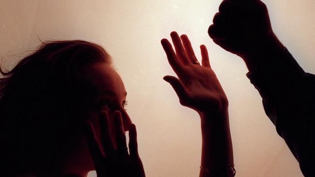 Domestic violence silhouette generic image - fist raised against woman./Violence