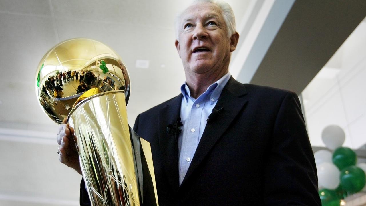 NBA legend John Havlicek holds the Larry O'Brien NBA Championship Trophy in 2008.