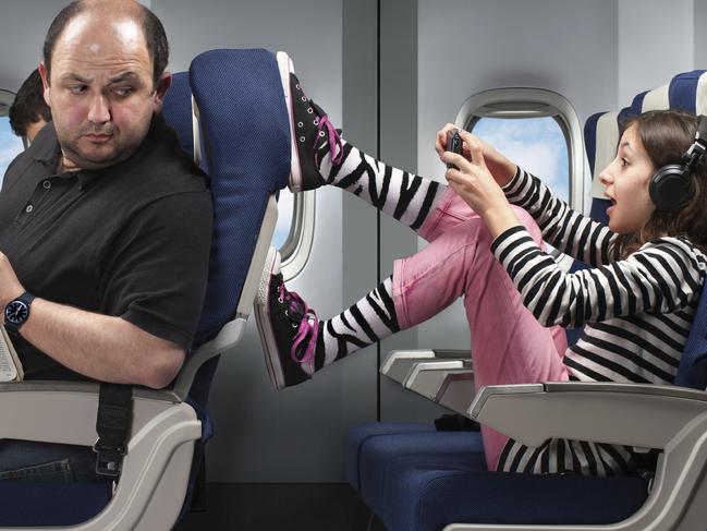 Annoying child with feet on seat in a plane