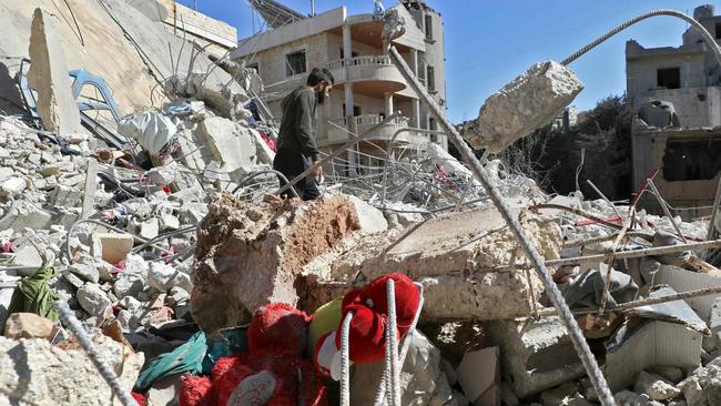 A man walks in the rubble at the site of an Israeli airstrike that targeted the eastern Lebanese village of Nabi Sheeth on Saturday. Iran, which backs the Hezbollah militants, has downplayed Israel’s strike there. Picture: Nidal Solh/AFP