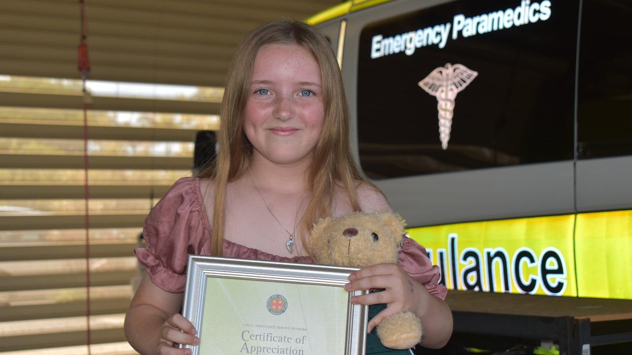 Madison Jennings accepted her certificate of appreciation at Mackay South Ambulance station after rescuing her cousin from drowning. Picture: Lillian Watkins