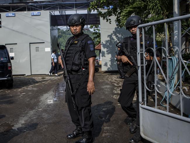 Indonesian police stand guard at Wijayapura port, the entrance gate to Nusakambangan prison, ahead of a third round of drug executions which were carried out in Indonesia this morning. Picture: Ulet Ifansasti