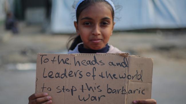 Palestinian children hold placards during a march demanding an end to the war and their right to live, education and play in Rafah, Gaza. Picture: Getty Images