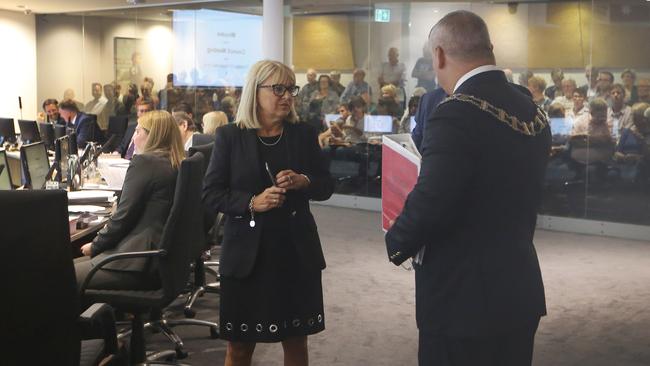 Protestors, including members of the Main beach Asociation, inside Gold Coast City Council objecting to Sunlands Hi Rise proposal at the Spit. Deputy Mayor Donna Gates in last minute talks with the Mayor Tom Tate and Cameron Caldwell before the meeting begins. Picture Glenn Hampson