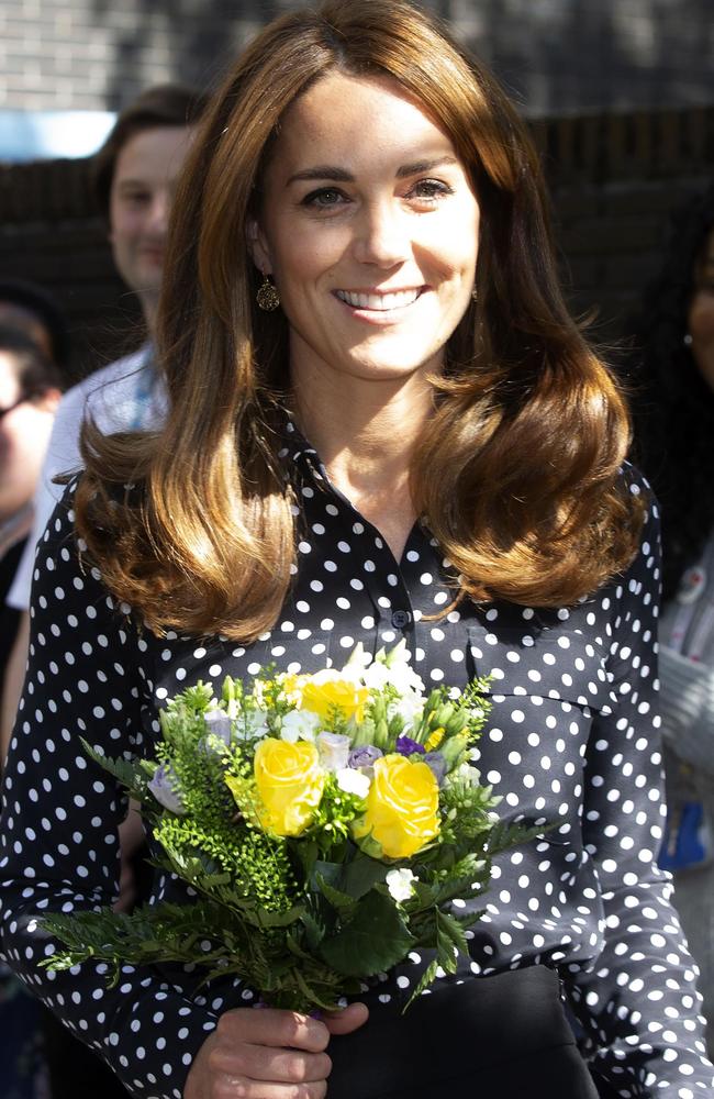 Britain's Catherine, Duchess of Cambridge carries a posy as she leaves after her visit to the Sunshine House Children and Young People's Health and Development Centre. Picture: AFP