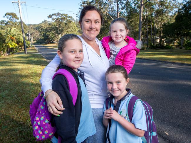 Lydene Heslop with her three children Samara, 9, Lexi, 7, and Izzy, 4, who lives on Benaroon Dr, now walks her children to the bus stop each morning since the disappearance of William Tyrrell. Picture: Lindsay Moller