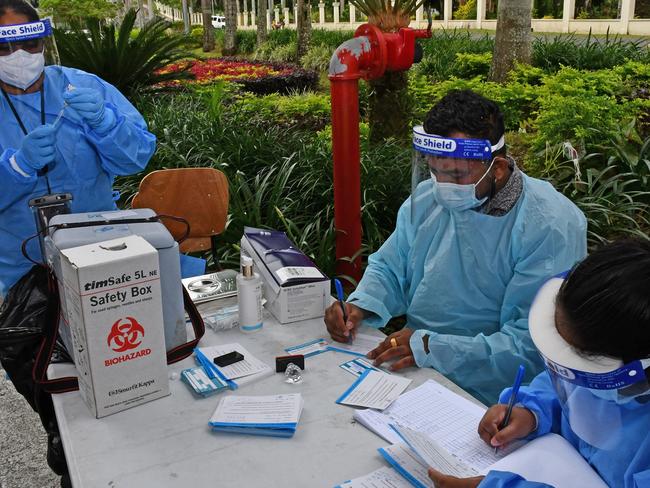 Health care workers prepare vaccination paperwork ahead of administering the AstraZeneca vaccine at a drive-through in Albert Park in Suva, Fiji. Source: Fijian Government