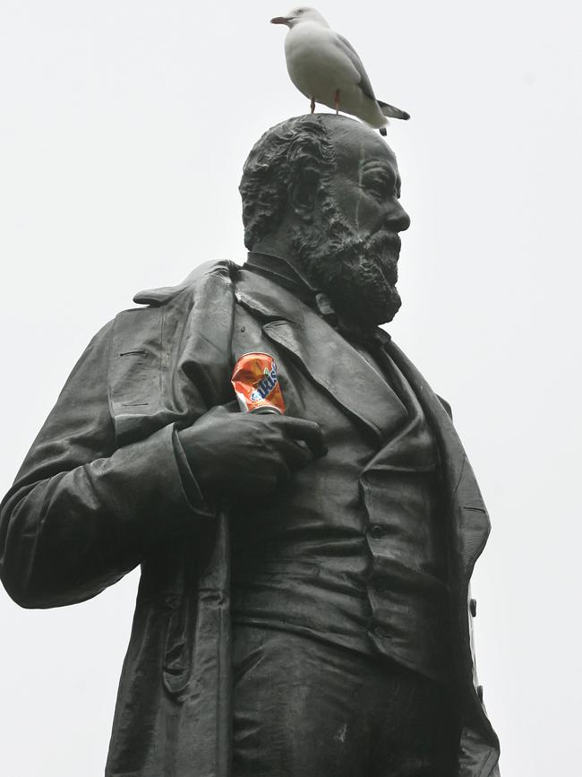 Former premier William Crowther with a can of soft drink and seagull perched on his head.