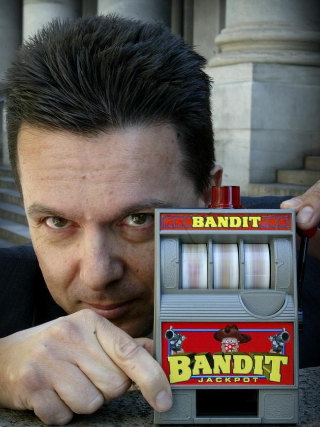 Little focus: SA politician Nick Xenophon showing off a toy poker machine in 2006.