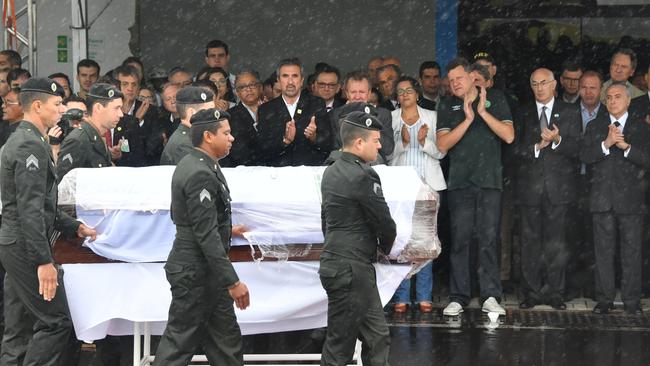 Brazilian President Michel Temer (far right) applauds as one of the coffins passes by. Picture: AFP/Nelson Almeida