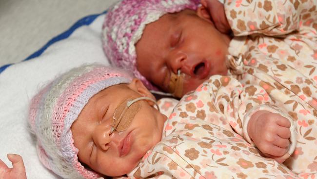 Pre-term identical twins Harper and Ayla Rafter born during the height of the storm last Saturday pictured with mum and dad Chloe and Jordan Rafter and big sister Addalyn. Picture: Shae Beplate.