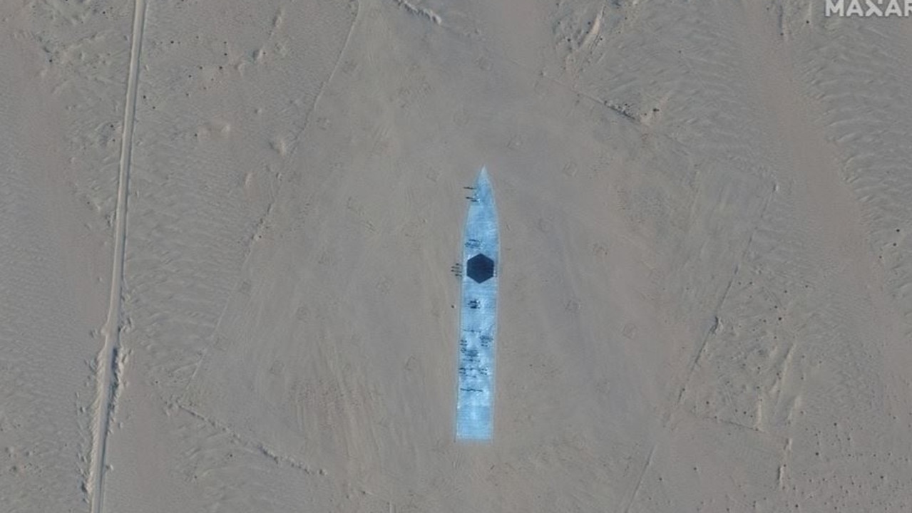 This satellite image, taken last year, shows the profile of a US Navy guided missile destroyer stamped in the middle of the Taklamakan Desert missile test range. Source: Maxar Technologies.