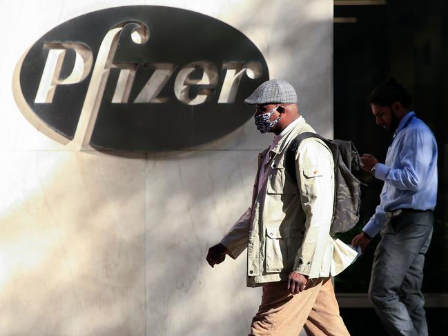 People walk by the Pfizer world headquarters in New York. Picture: AFP