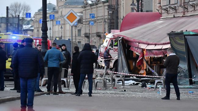 Russian police investigators inspect the bar where the blogger was blown up. Picture: AFP.