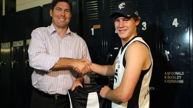 Carlton's no. 1 draft pick Bryce Gibbs receives the no. 4 jumper from Stephen Kernahan.