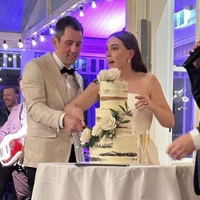 Groom Mitchell Gaffney and bride Madeleine Edsel cut their cake.