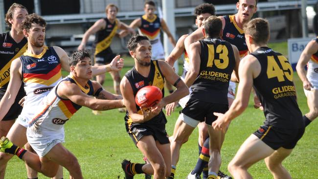 Glenelg's Ian Milera dishes out a handpass during his team’s win at Bordertown.