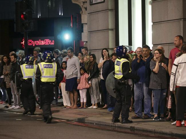 Guests from the Premier Inn Bankside Hotel are evacuated and kept in a group with police on Upper Thames Street following an incident in central London. Picture: PA via AP