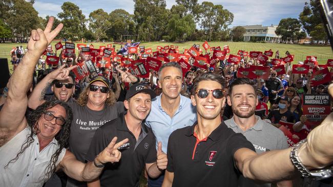 Racing Car Driver Nick Percat takes a selfie with L to R Musician Vince from Zep Boys, Musician Crafty, Dave Gleeson from the Screaming Jets, fellow race driver, Todd Hazelwood, MP Peter Malinauskas, fellow race driver Scott Pye, and the crowd of Adelaide 500 Motor Car race enthusiasts at Civic Park, Modbury. Picture: Emma Brasier