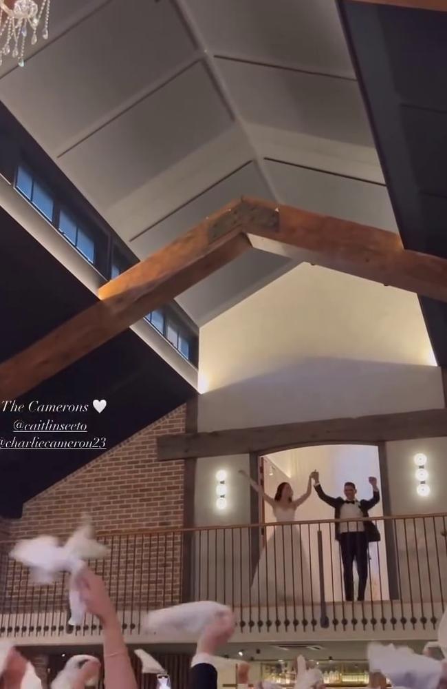 Charlie Cameron and Caitlin dancing on a balcony at their wedding reception. Photo: Instagram.