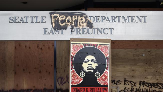 A 1970s-era poster of activist Angela Davis hangs at a boarded up and closed Seattle police precinct, where streets are blocked off in what has been named the Capitol Hill Occupied Protest zone. Picture: AP.