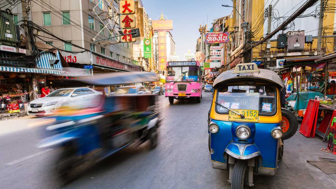 A tuk-tuk taxi parked near a street market in Bangkok, Thailand. Picture: ErmakovaElena