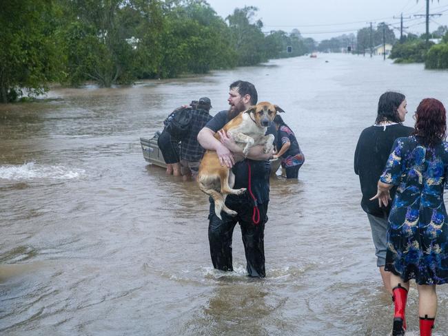 Lismore resident Cristen Twomey makes his way to safety after being rescued from his flooded home in Lismore on February 28, 2022. Picture: Media Mode