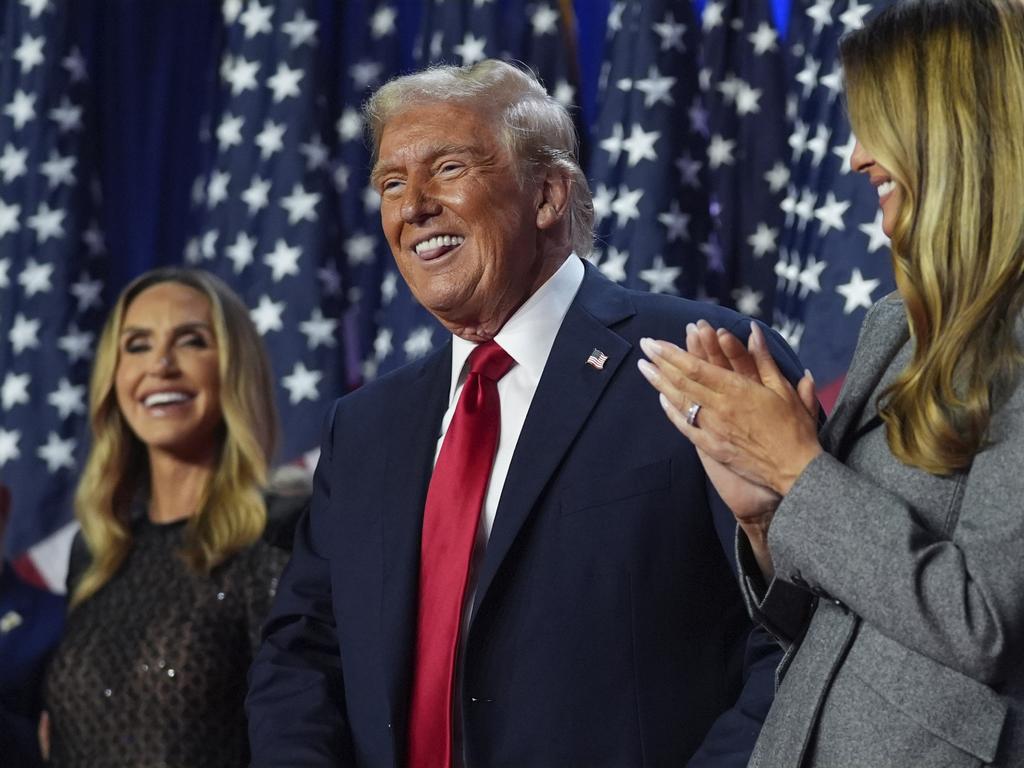 Donald Trump stands on stage with first lady Melania Trump after his election win. Picture: AP