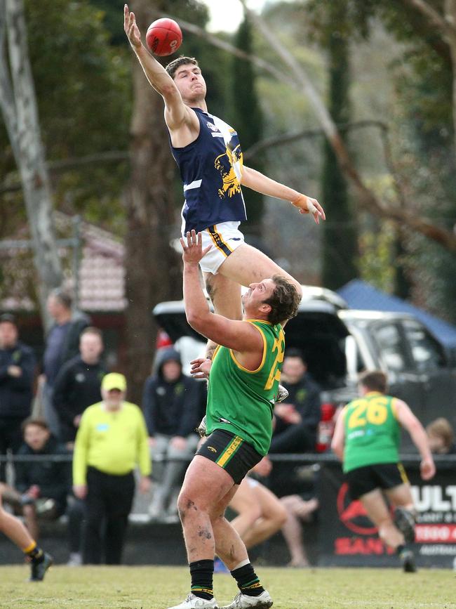 EFL: Beaconsfield’s Harrison Coe leaps high over Bryce Galvin of Bayswater. Picture: Hamish Blair