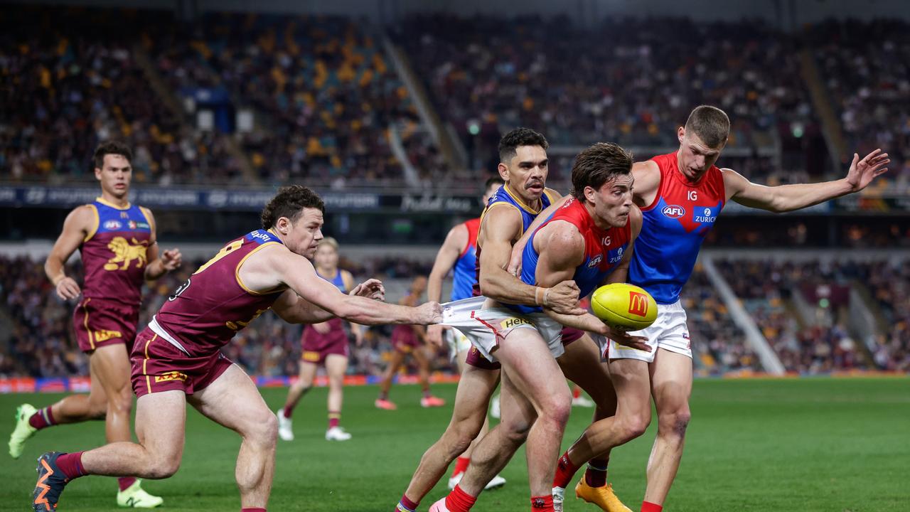 Lachie Neale tackles Jack Viney. (Photo by Russell Freeman/AFL Photos via Getty Images)