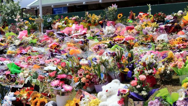 Floral tributes left on the front lawn of Dreamworld for the victims. Pic Tim Marsden