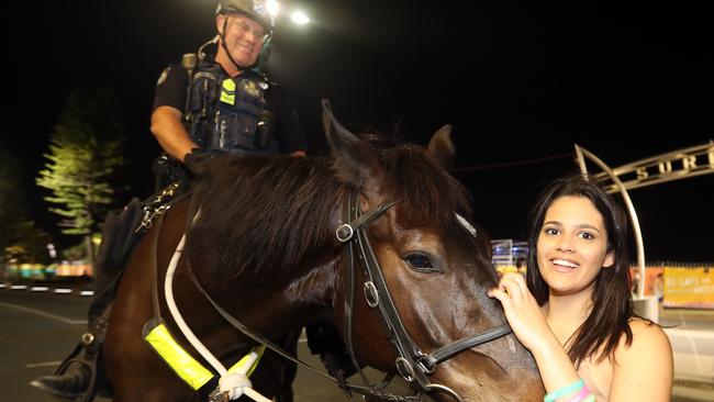 Schoolies Thursday night. Alex Kelly with Snr Cnst Dave Masters on Judo the police horse. Picture: Richard Gosling