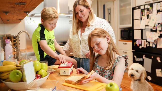 Sandra Senn poacks lunch boxes with her children, Murphy, 8 and six-year-old Garrison as their dog, Beau, watches on. Picture: Russell Millard Photography