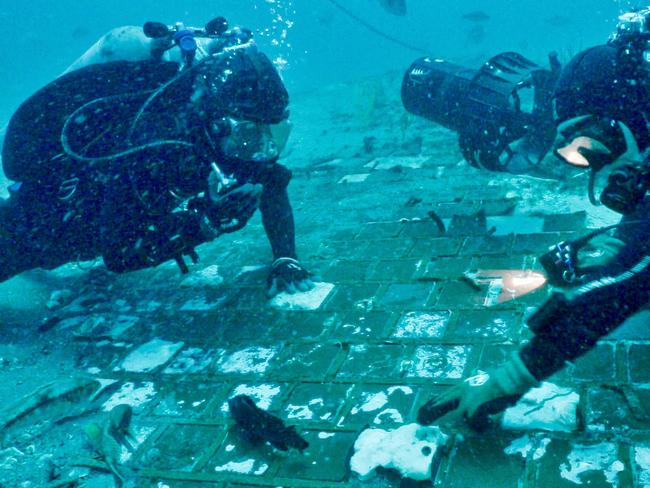 This handout picture provided by The History Channel on November 10, 2022 shows underwater explorer and marine biologist Mike Barnette and wreck diver Jimmy Gadomski exploring a twenty-foot segment of the 1986 Space Shuttle Challenger discovered in the waters off the coast of Florida during the filming of the new series âThe Bermuda Triangle: Into Cursed Watersâ. - Divers searching for a World War II-era aircraft in the Bermuda Triangle have found a piece of an entirely different sort of vessel: part of the US Challenger space shuttle that exploded after takeoff in 1986. The shuttle exploded several dozen seconds after launching from Florida, causing the death of seven crew members, including the teacher Christa McAuliffe who had won a national screening. (Photo by Handout / The History Channel / AFP) / RESTRICTED TO EDITORIAL USE - MANDATORY CREDIT "AFP PHOTO /  The History Channel" - NO MARKETING - NO ADVERTISING CAMPAIGNS - DISTRIBUTED AS A SERVICE TO CLIENTS / TO GO WITH AFP STORY by Lucie AUBOURG, "Piece of Challenger space shuttle found off Florida coast"