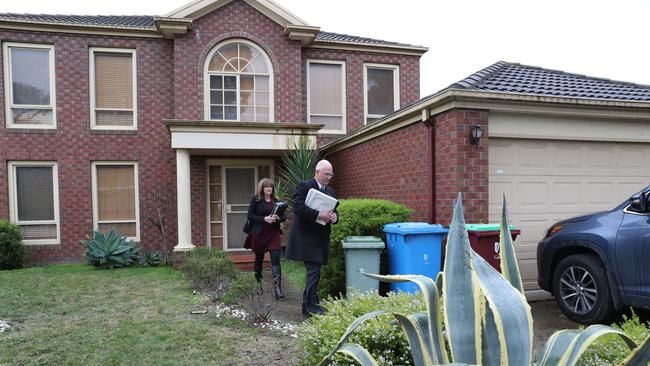 Two officials at Adem Somyurek’s home this afternoon. Picture: David Crosling